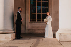 Bride and groom looking at each other in the evening sunlight