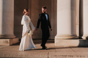 Bride and groom walking at Cardiff Museum