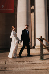 Candid moment of groom looking at bride while walking