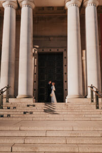 Wide portrait of bride and groom at golden hour in Cardiff