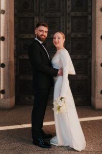 Bride and groom smiling at golden hour in Cardiff