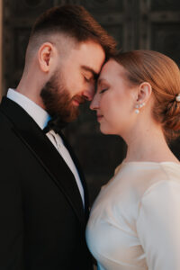 Bride and groom placing their foreheads together