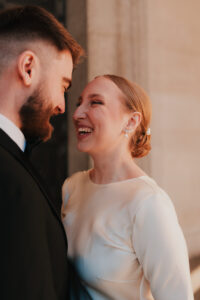 Candid laugh from the bride at Cardiff Museum during Golden Hour