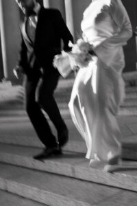 Bride and groom's wedding attire with shutter drag in black-and-white