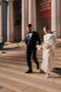 Bride and groom running at Cardiff Museum