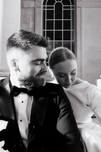 Black-and-white portrait of bride and groom, candid moment