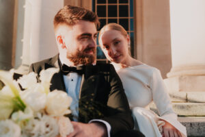 Groom looks away while the bride looks at the camera in Cardiff