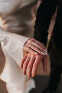 Bride and groom showing their wedding rings