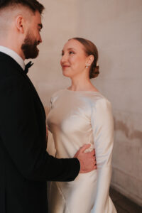 Groom holding and looking at bride