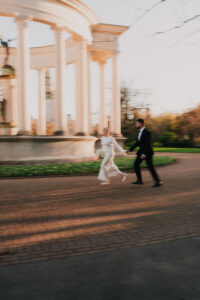 Bride and groom running in Alexandra Gardens