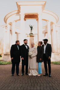 Bride and groom with close family for a micro wedding group portrait
