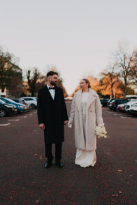 Bride and groom walking on King Edward VII Avenue in Cardiff
