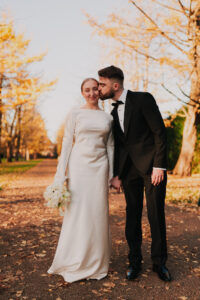 Groom kissing bride's cheek in Cardiff