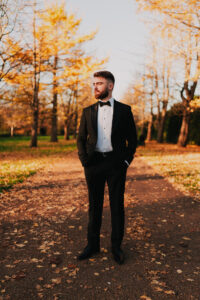 Groom standing in solo portrait in Cardiff