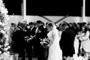 Black-and-white portrait of bride and groom praying before ceremony in Newport