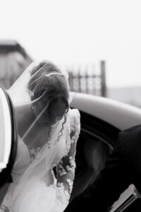 Black-and-white of bride arriving at Warehouse Church in Newport