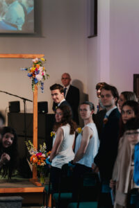 Groom smiling as the bride walks down the aisle