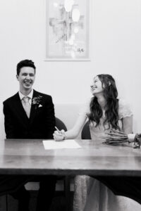 Candid portrait of bride and groom laughing in Ruislip London, black-and-white