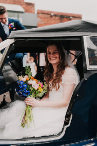 Bride smiling outside Waterloo Road Church in Ruislip, London