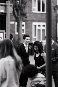 Black-and-white candid moment of groom in Ruislip London
