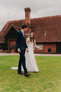 Candid portrait of bride and groom walking at The Great Barn in Ruislip London