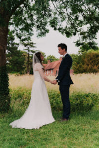 Formal portrait of bride and groom facing each other in Ruislip London