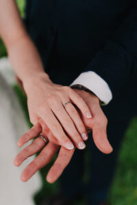 Portrait of bride and grooms hands and wedding rings