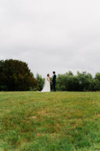 Wide portrait of bride and groom on the grounds at The Great Barn in Ruislip